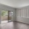 a room with a wood floor and a glass door