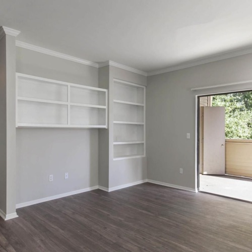 Beautiful living spaces with natural lighting a room with a wood floor and a wood floor with a glass door